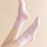 Pink socks worn on a light beige background