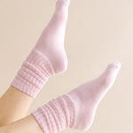 Pink socks worn on a beige background