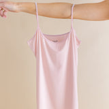 Pink tank worn by a person on a beige background