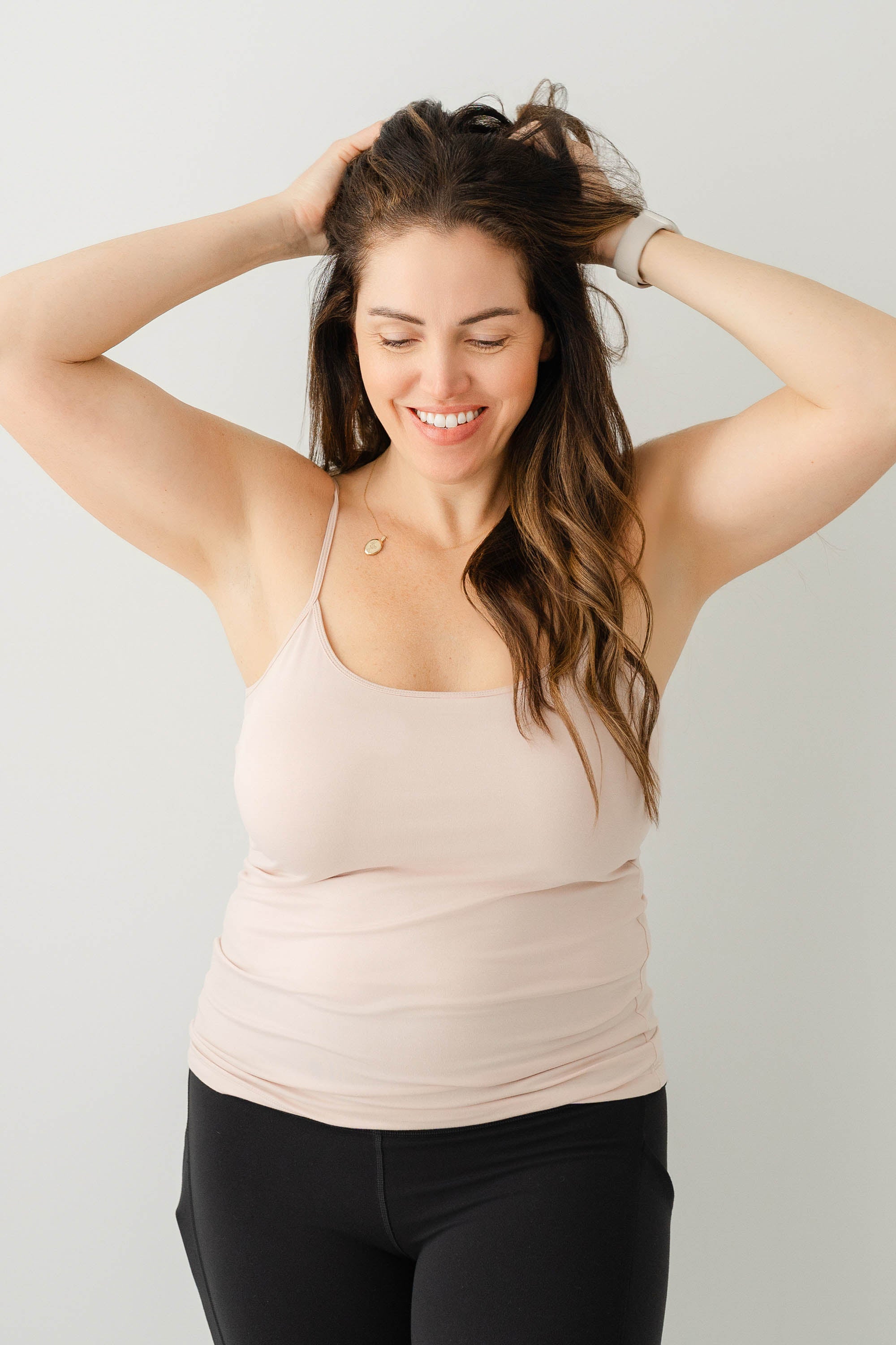 Model wearing the Women’s Camisole in Blush and black pants