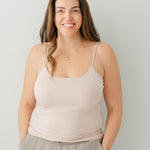 Female model wearing the Women’s Camisole in Blush and tan pants