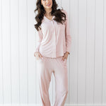 Model wearing the Kyte Long Sleeve Women's Pajama Set in Blush with Cloud Trim 