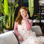 Modal posing in Adult Sleep Bag Walker in Book Club print sitting on a sofa