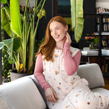 Modal posing in Adult Sleep Bag Walker in Book Club print sitting on a sofa
