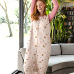 Modal posing in Adult Sleep Bag Walker in Book Club print standing in a living room