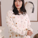 Modal posing in a room wearing Beige Long Sleeve Adult Sleep Bag Walker in Book Club print