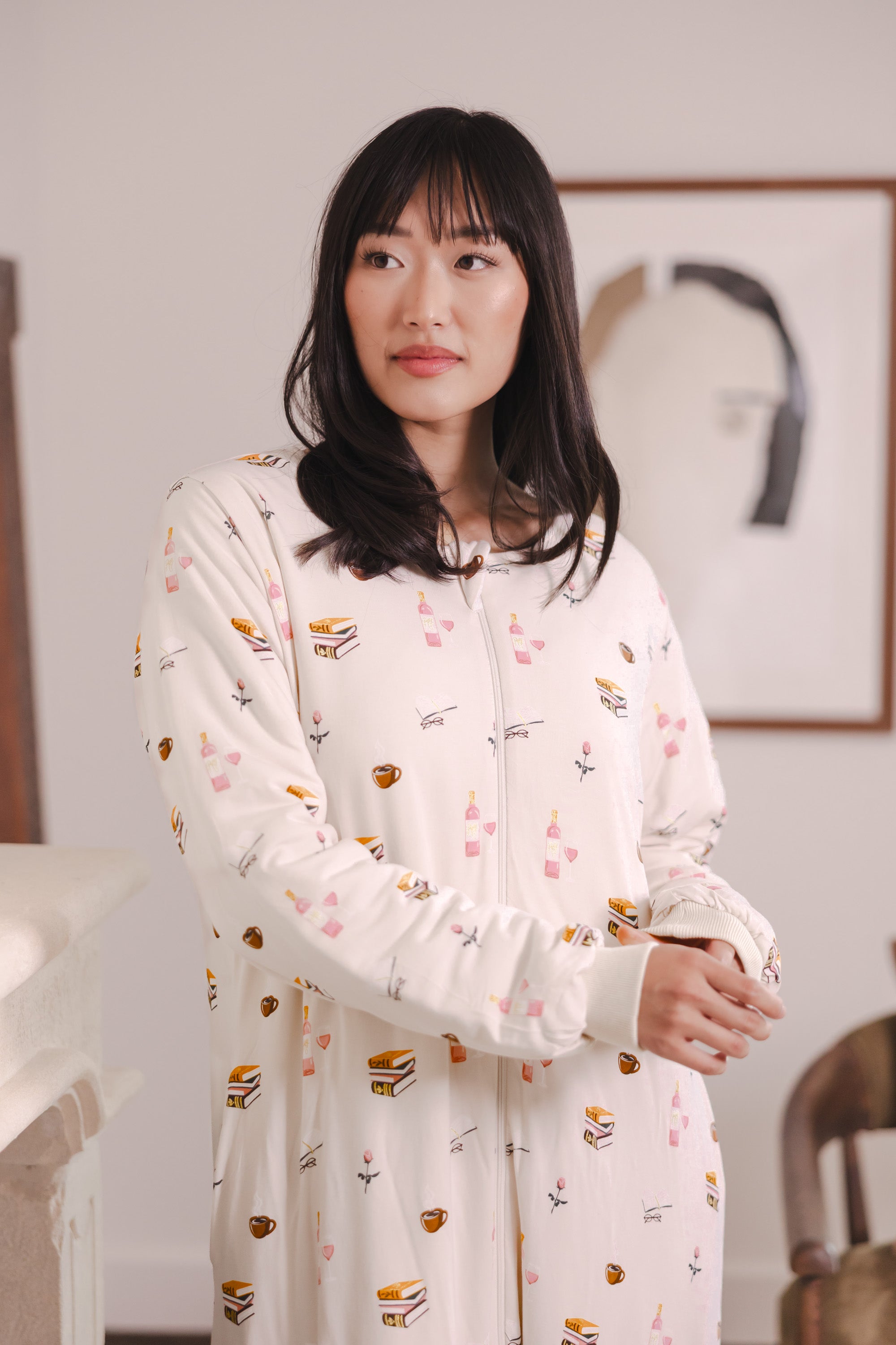Modal posing in a room wearing Beige Long Sleeve Adult Sleep Bag Walker in Book Club print