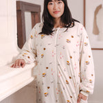Modal standing wearing Beige Long Sleeve Adult Sleep Bag Walker in Book Club print