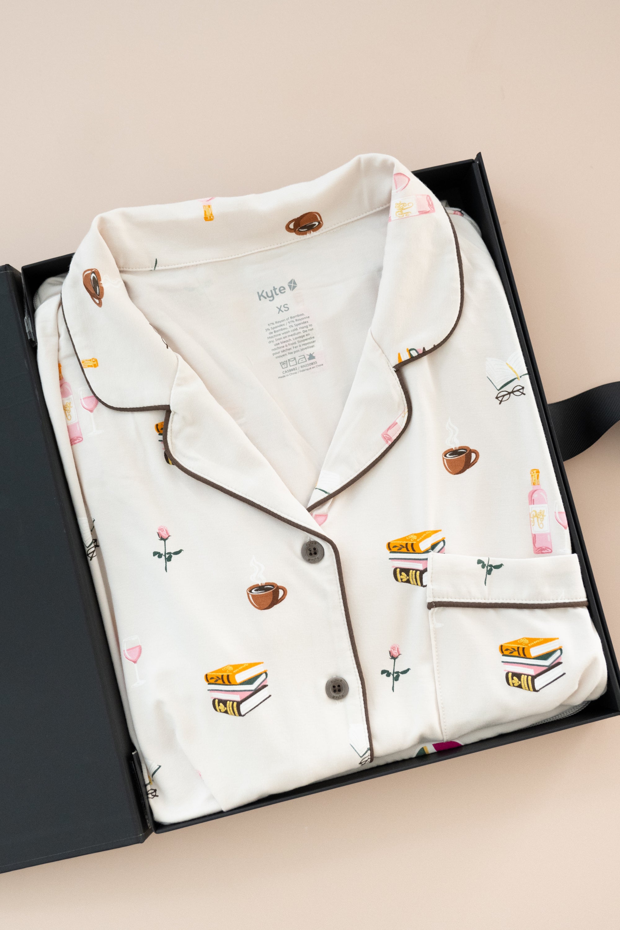 Long-Sleeved Women's Pajama Set in Book Club print packed in a box on a beige background