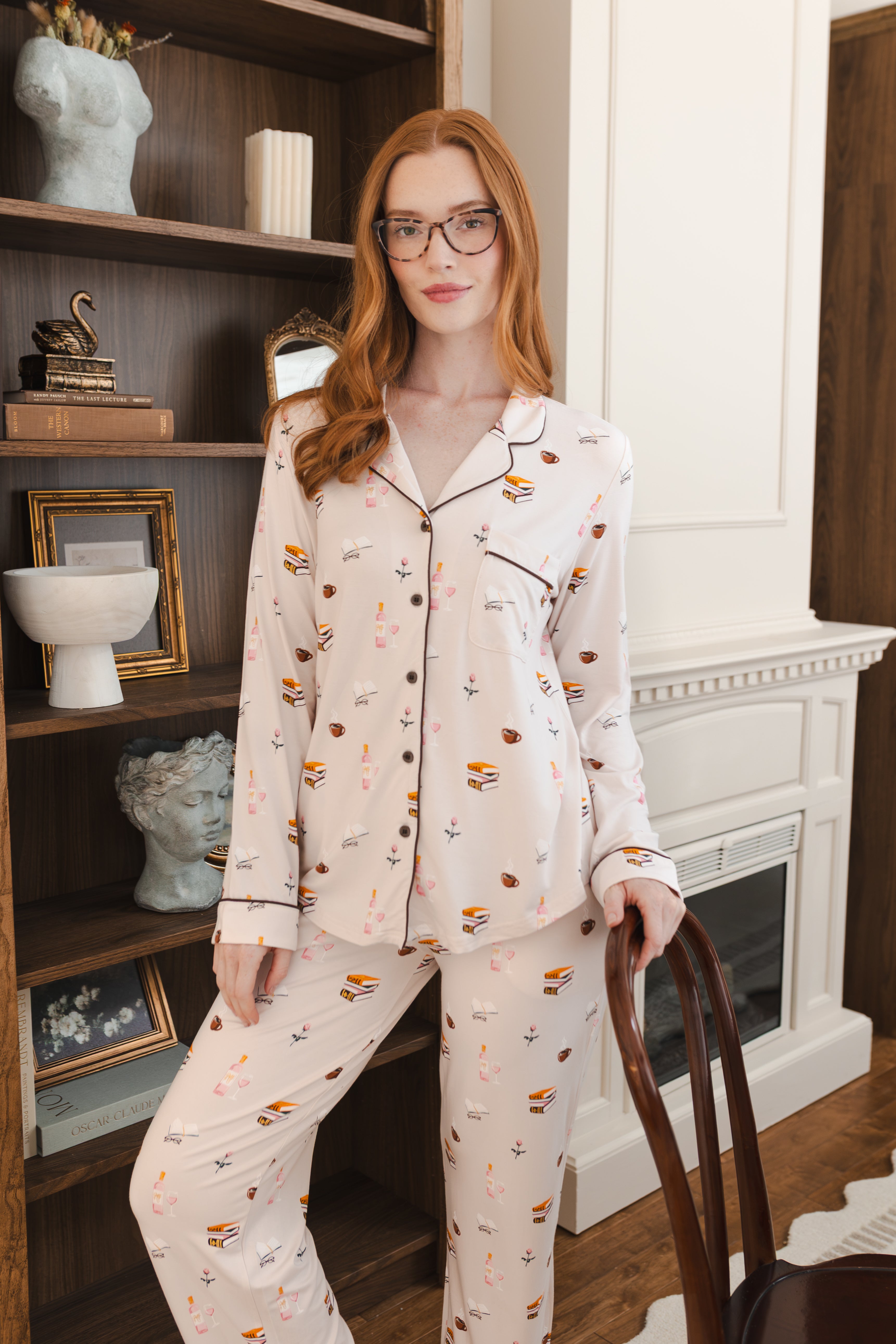 Modal wearing Long-Sleeved Women's Pajama Set in Book Club print posing in a living room
::: Model is 5'8"" wearing size S ///
---PJ 2