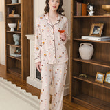 Modal wearing Long-Sleeved Women's Pajama Set in Book Club print posing in a study holding a drink in hand
---PJ 4