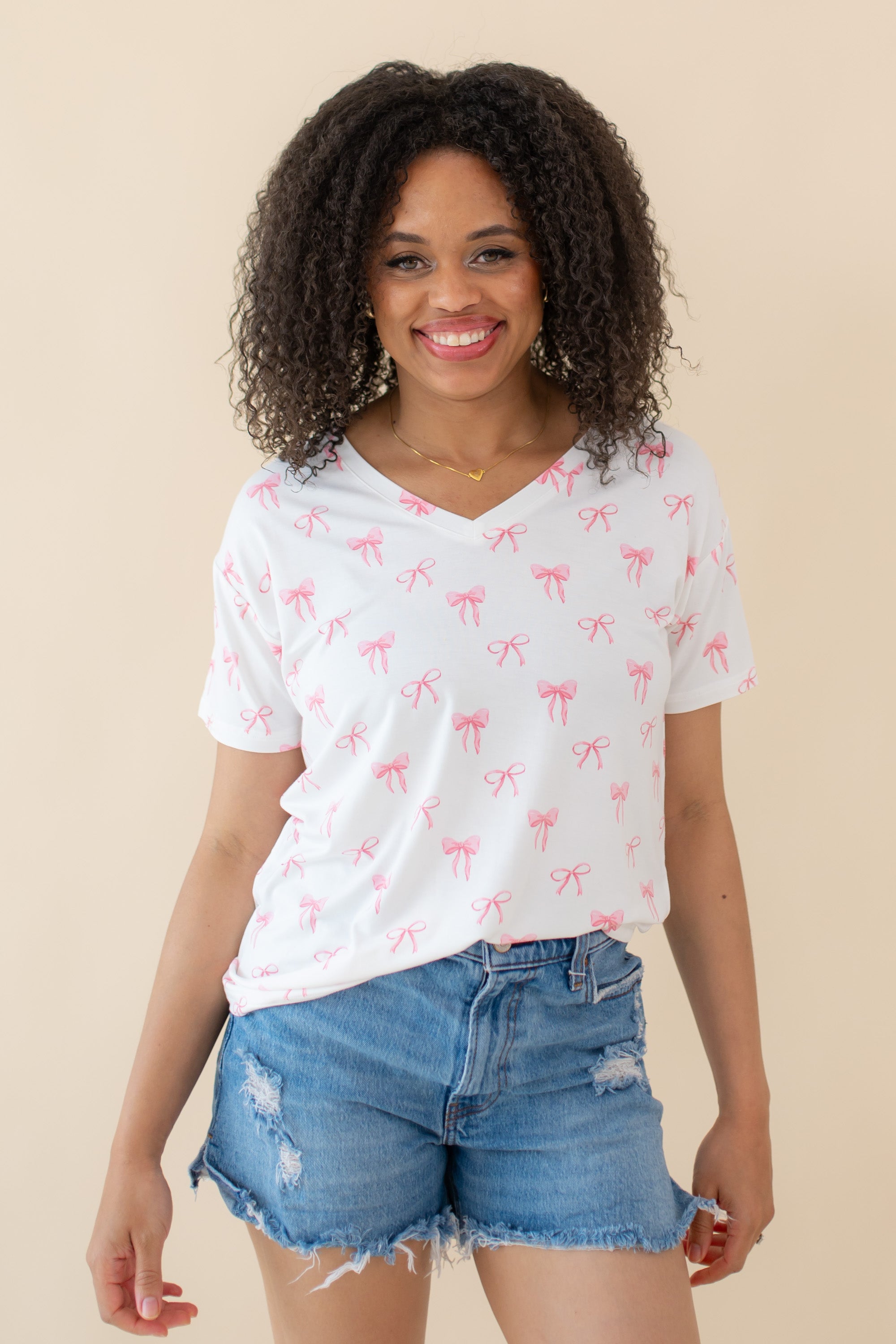Woman modeling Women’s Relaxed Fit V-Neck in Bow and jean shorts