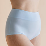 Light blue underwear worn by a person on a beige background