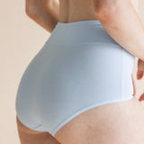 Model show casing the back side of the High Waisted Brief in Breeze 