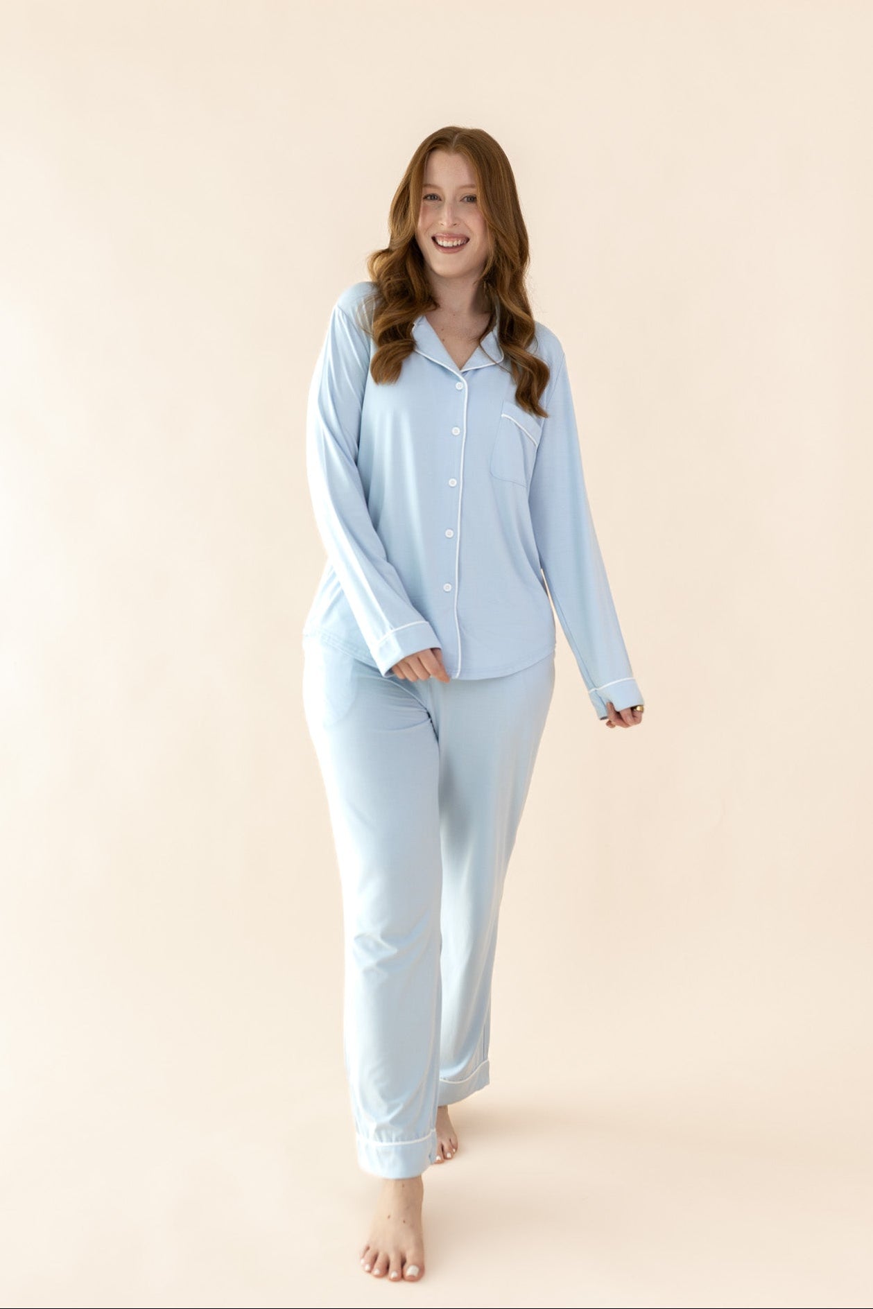 Smiling model stepping towards camera while wearing the Bamboo Long-Sleeved Women's Pajama Set in Breeze  ::: Model is 5'7" wearing size M ///