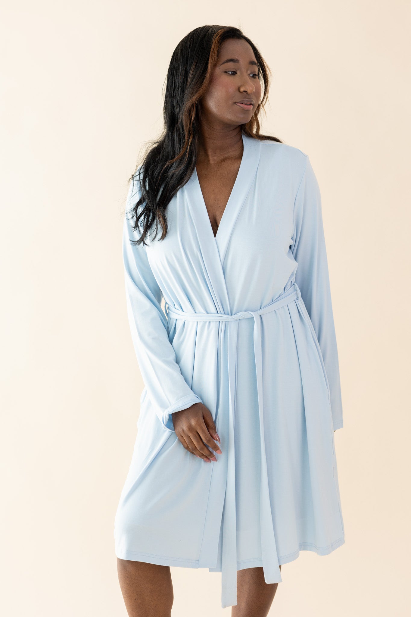 Model looking to the side while wearing the tied up Bamboo Women's Lounge Robe in Breeze  