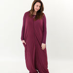 Model looking down to the floor while wearing the Adult Sleep Bag Walker in Burgundy 