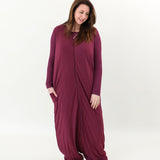 Model looking down to the floor while wearing the Adult Sleep Bag Walker in Burgundy 