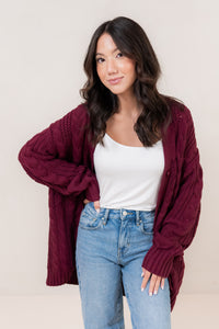 Burgundy chunky knit cardigan, angled front view showing texture
