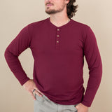Close up of model wearing Kyte Long Sleeve Henley Tee in Burgundy 