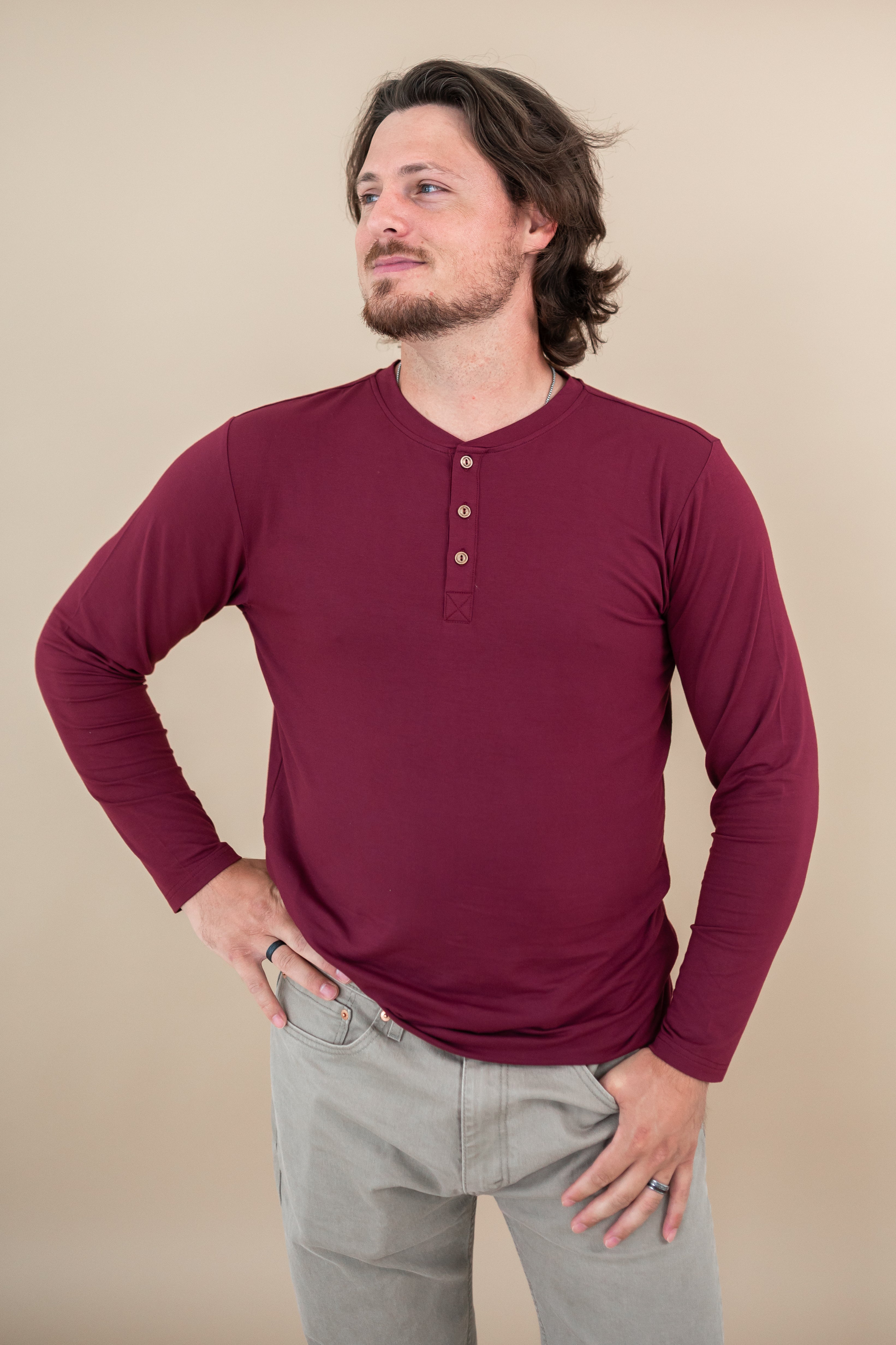 Close up of model wearing Kyte Long Sleeve Henley Tee in Burgundy 