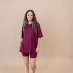 Smiling model walking towards camera while wearing the  Women's Biker Short Set in Burgundy