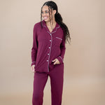 Smiling model looking to the side while wearing the Women's Long Sleeve Pajama Set in Burgundy