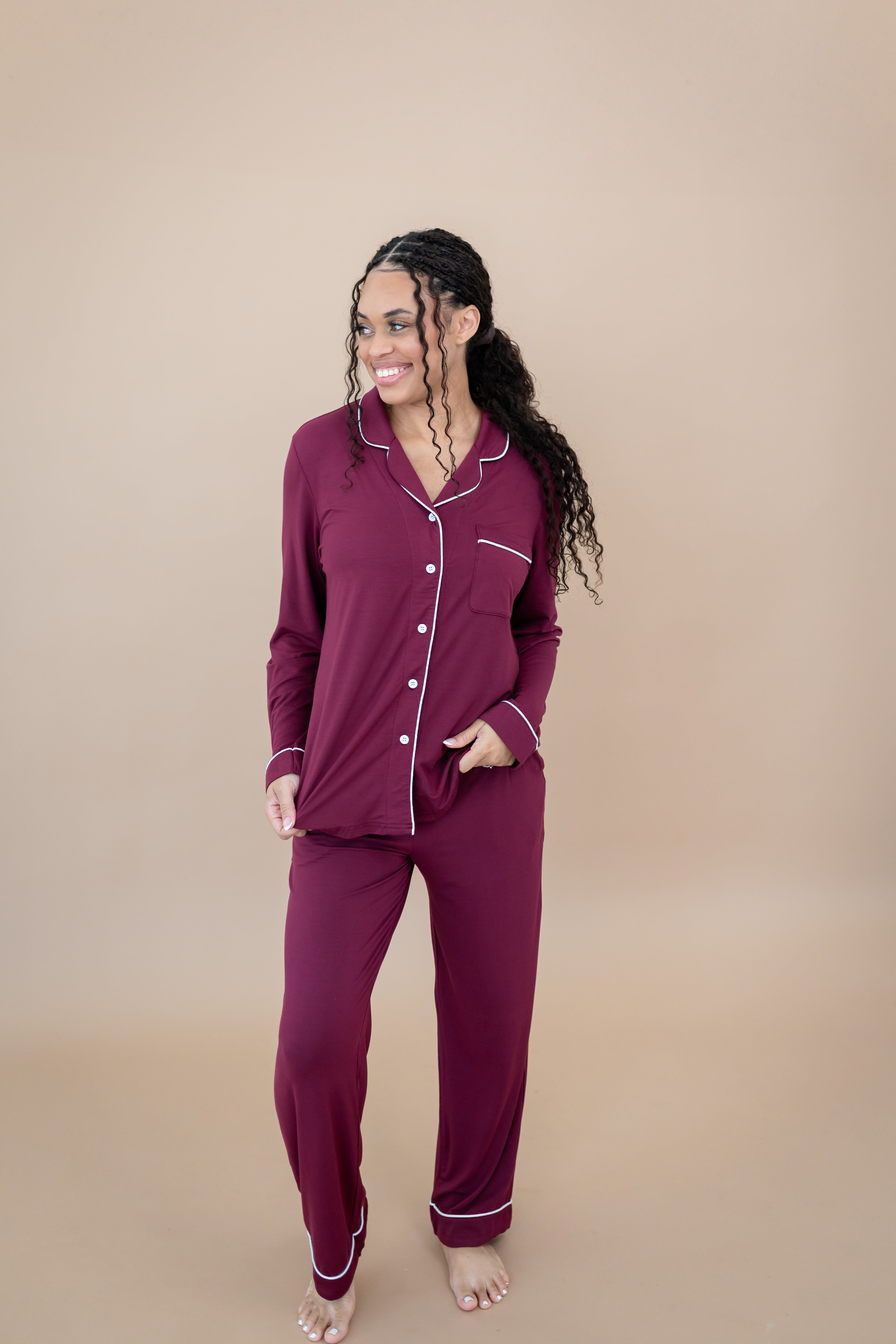 Smiling model looking to the side while wearing the Women's Long Sleeve Pajama Set in Burgundy