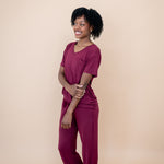 Smiling  model wearing matching V Neck and Lounge Pants in Burgundy