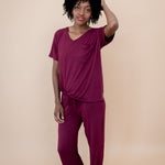 Model with hand in her hair while wearing the Lounge Pants in Burgundy