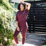 Female standing outside wearing the Bamboo Flex Women’s Leggings in Burgundy with matching short sleeve tee