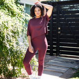 Female standing outside wearing the Bamboo Flex Women’s Leggings in Burgundy with matching short sleeve tee