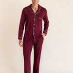 Model wearing Men's Long Sleeve Pajama Set in Burgundy on a beige background