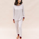 Model looking to the side while wearing the Women's RIbbed Henley Set in Burgundy Stripe