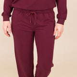 Modal wearing Women's Jogger Pant in Burgundy color under similar color sweatshirt on a beige background
::: Model is 5'9" wearing size S ///