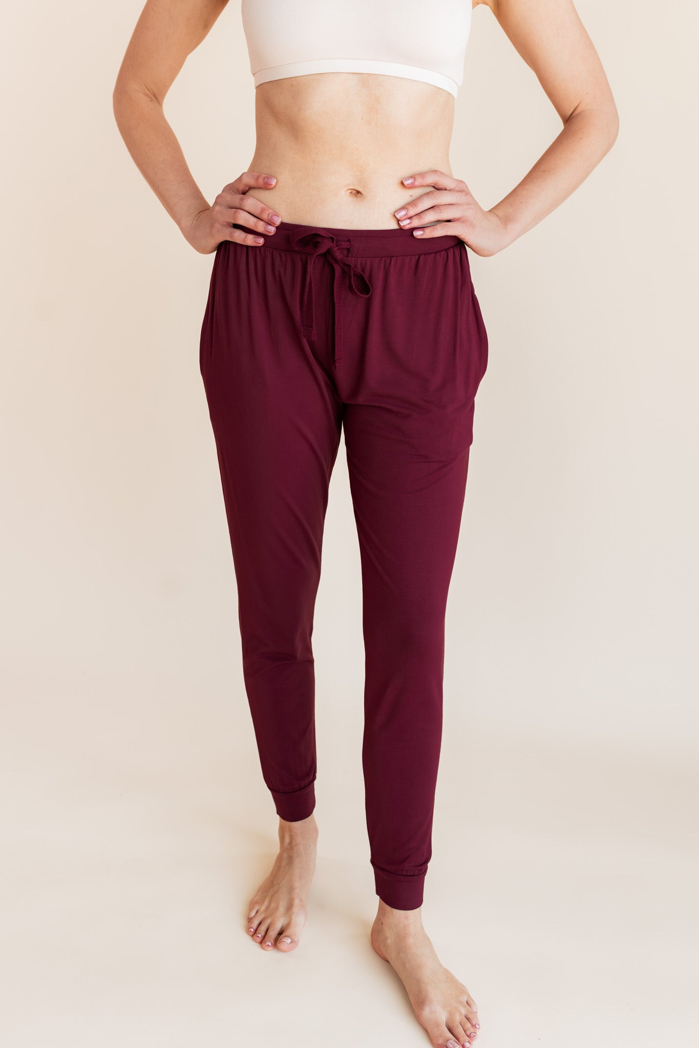 Model wearing burgundy jogger pant with drawstring waist and neutral bralette
::: Model is 5'9" wearing size XS ///
