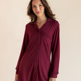 A woman modeling a long-sleeve button-front shirt dress in deep burgundy against a plain beige studio background.
::: Model is 5'9.5" wearing size XS ///