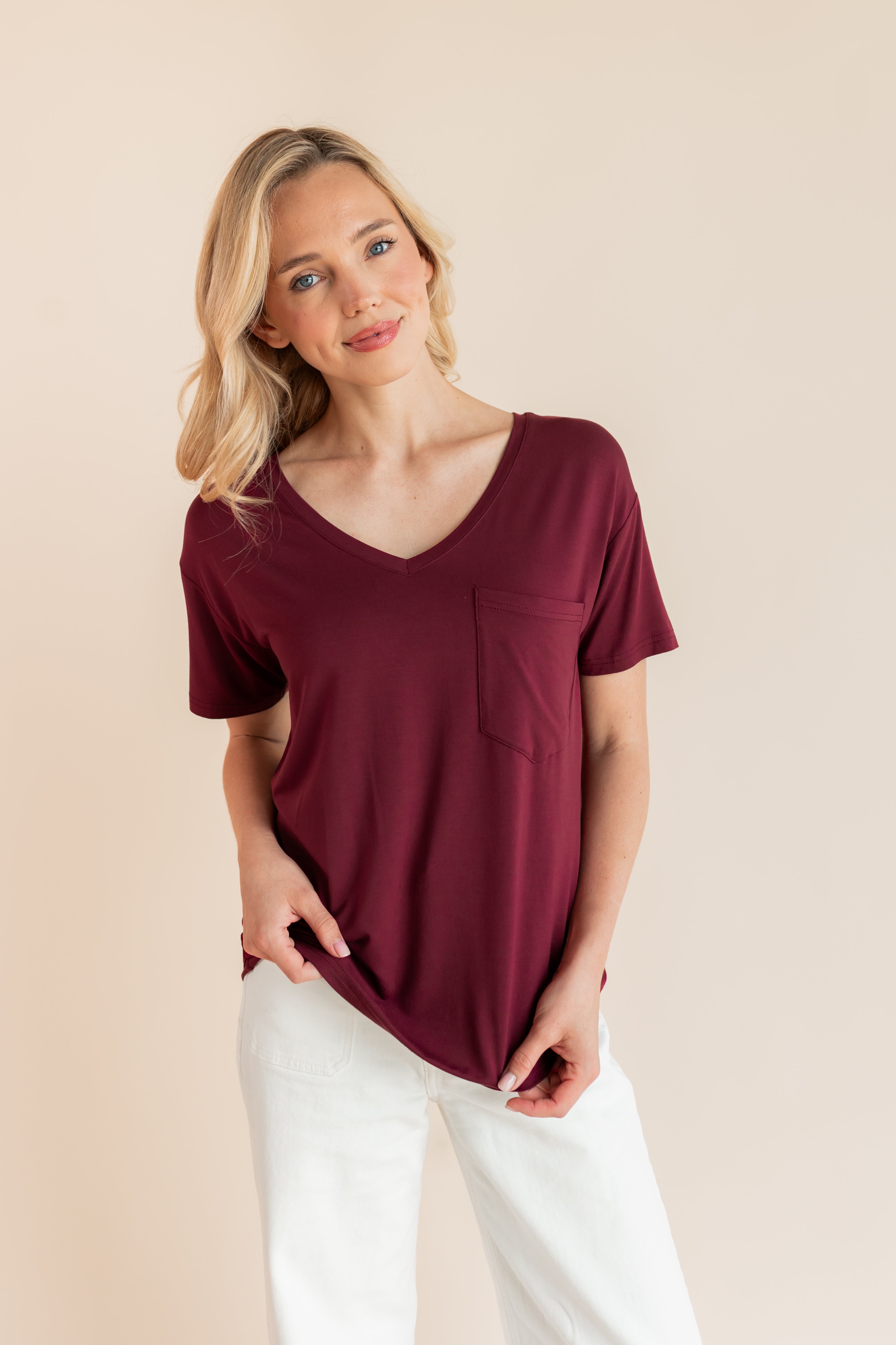 Model wearing Women's Oversized V-Neck Tee in Burgundy over white pants on a beige background
::: Model is 5'9" wearing size XS ///
