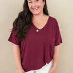 Woman model wearing the V Neck in Burgundy paired with white pants