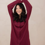 Woman with arms over her head while modeling the Women's Sleep Shirt in Burgundy