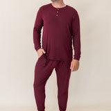 Model looking to the side with hand in pocket while wearing the Men's Ribbed Henley Set in Burgundy