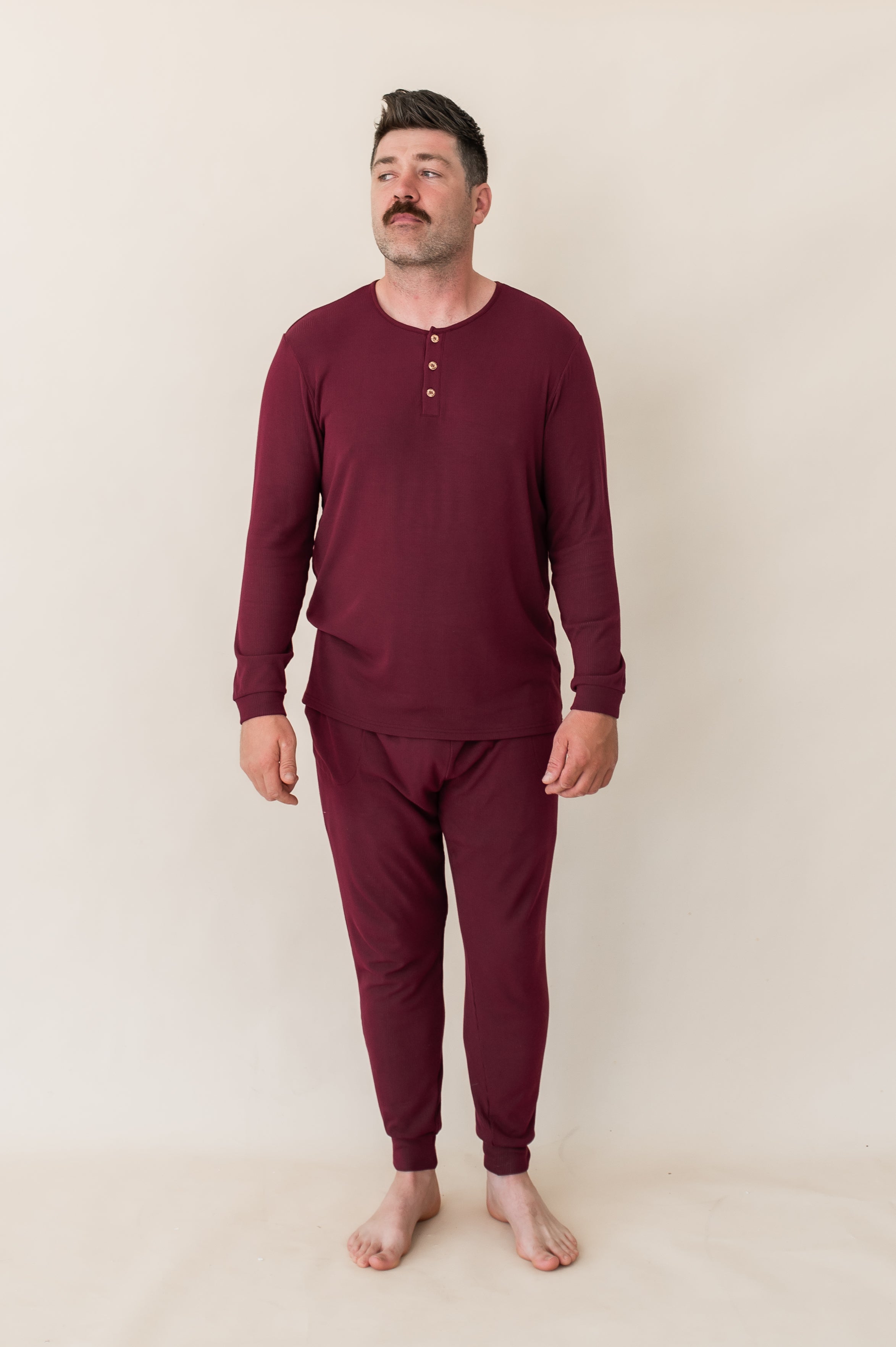 Man modeling the Kyte Men's Ribbed Henley Set in Burgundy