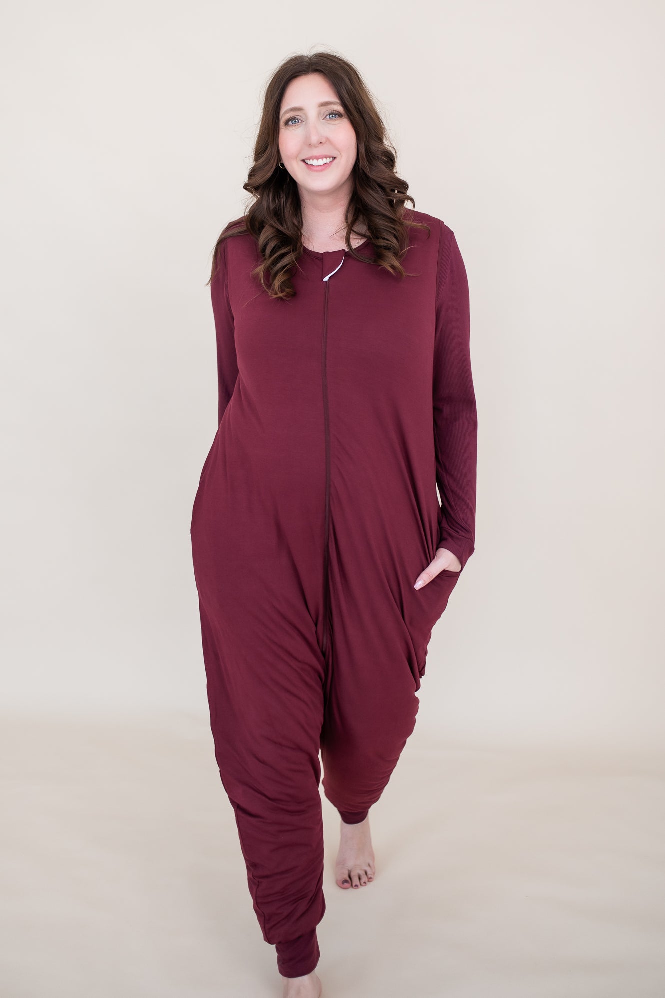 Model walking towards camera while wearing the Adult Sleep Bag Walker in Burgundy