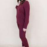 Model looking to the side while wearing the Women's Henley top in Burgundy paired with matching joggers