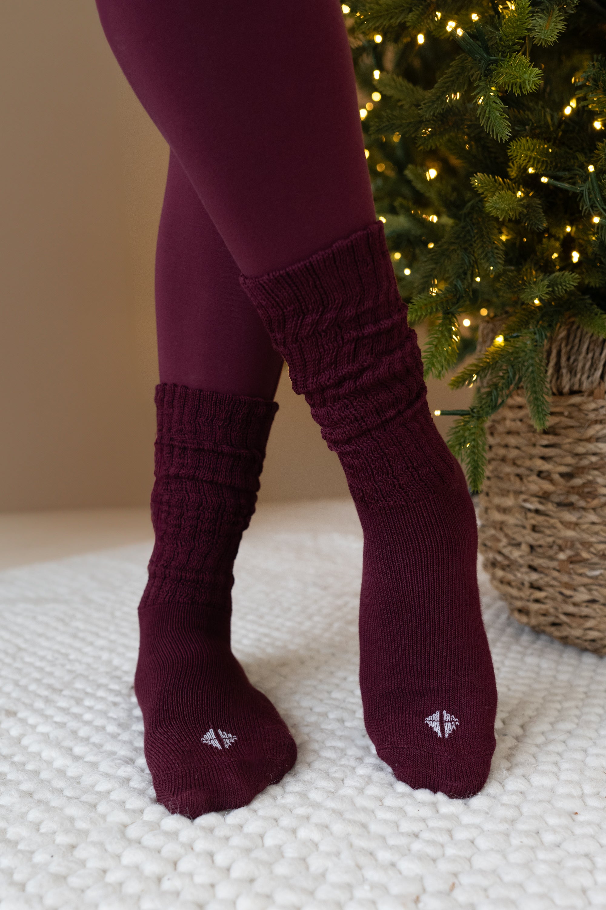 Person wearing Burgundy scrunched socks and matching leggings 