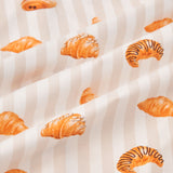 An all-over print of various types of croissants over a background of vertical stripes in white and a light beige color named Vanilla.
---1620 1