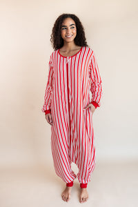 Woman wearing Long Sleeve Adult Sleep Bag Walker in red and white Peppermint Stripe print on a beige background