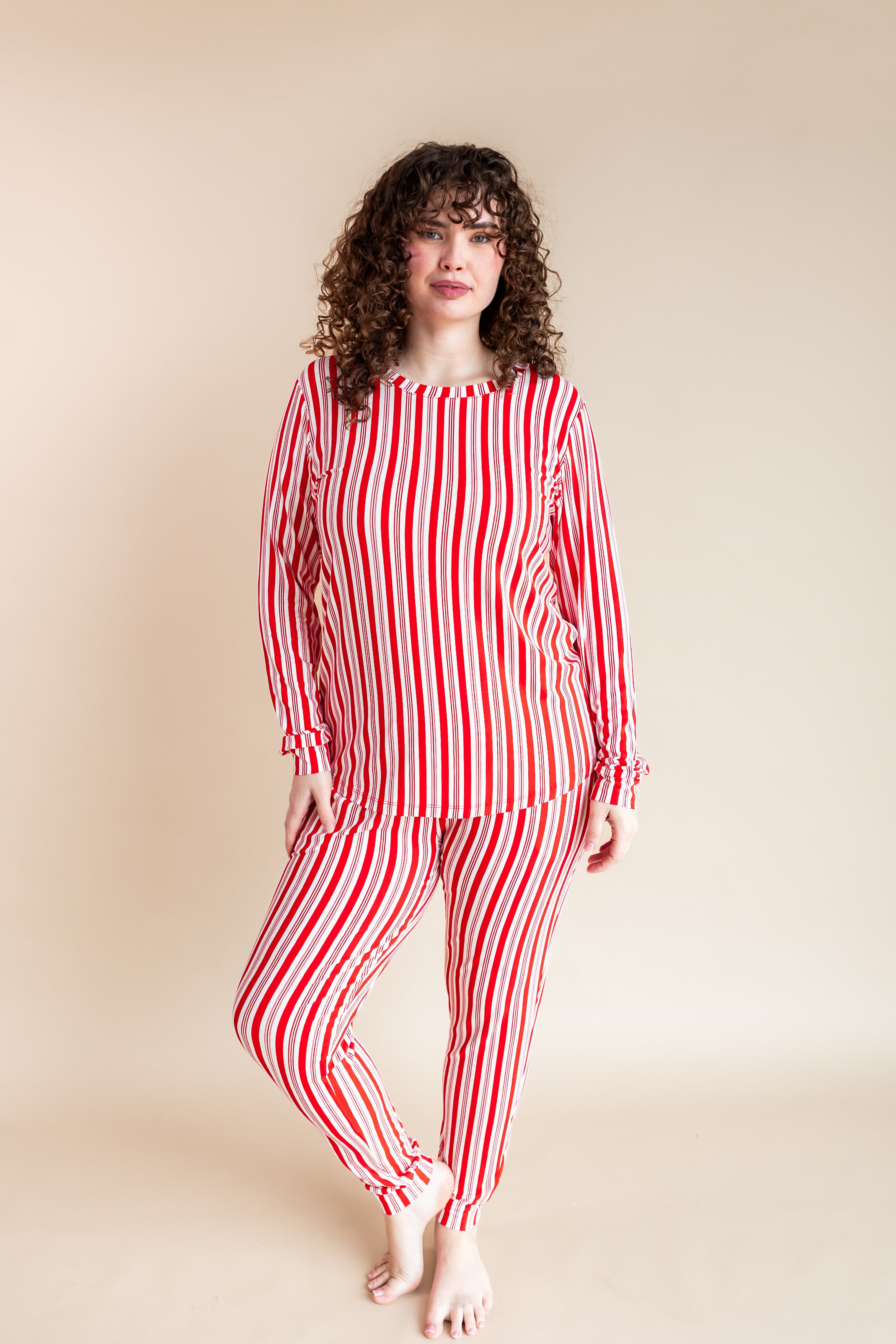 Woman wearing Women's Jogger Pajama Set in red and white Peppermint Stripes print on a beige background
::: Model is 5'10" wearing size XL ///