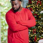 Model with arms crossed across chest and wearing the Men's Long Sleeve Henley Top in Cardinal