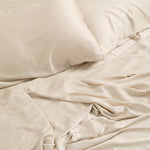 Close up of the Bamboo Sateen Sheet Set in Champagne shown on a bed